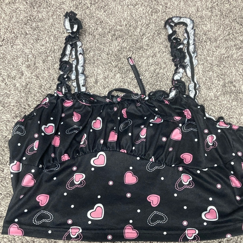 A black tank top with pink and white hearts